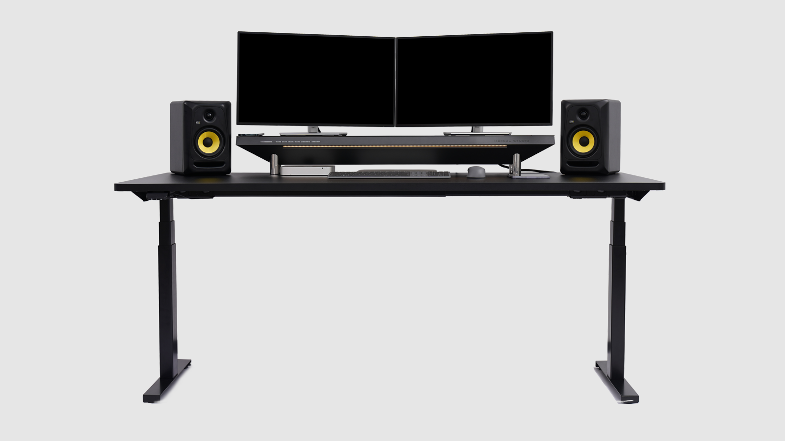The desk is clean and organized with Hexcal Studio monitor stand. This pictures shows a dual monitor setup with multiple devices.