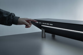 A user is turning on the Hexcal Studio's immersive task light system.